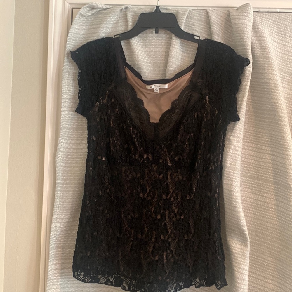 Lace over stretchy nylon pullover top with lacy cap sleeves. Deep V lace neck.